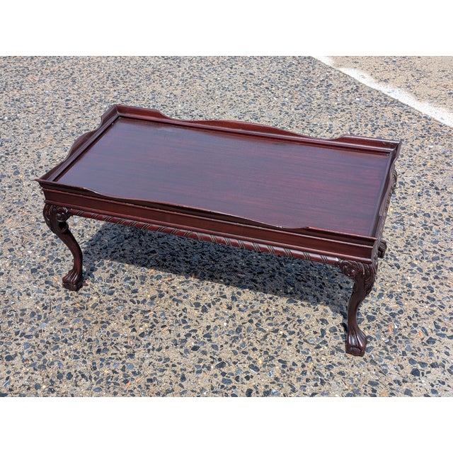 This Chippendale Style Mahogany Galleried Coffee Table is a magnificent centerpiece that captures the grand elegance of...
