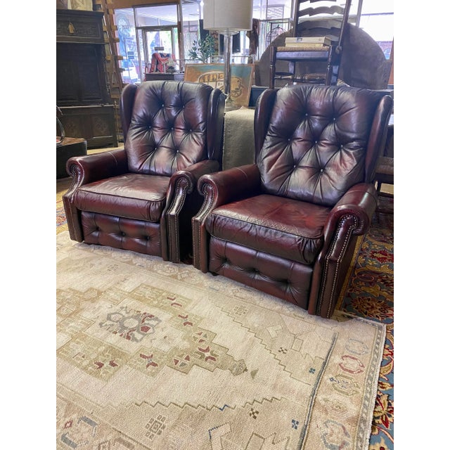 Very comfortable mid century English Oxblood leather “Easy Chairs”. Button and tufted backs and on bottom skirt. With a...