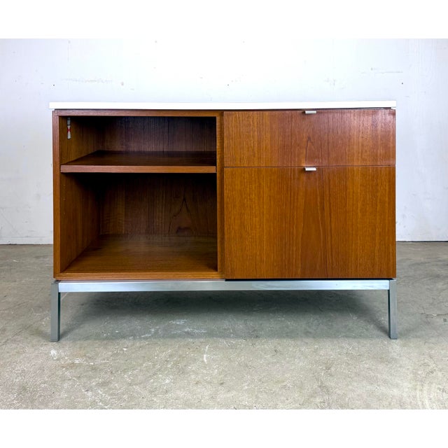 A beautiful, modestly-sized credenza cabinet by Florence Knoll for Knoll Furniture circa 1960’s. Features teak veneer, a...