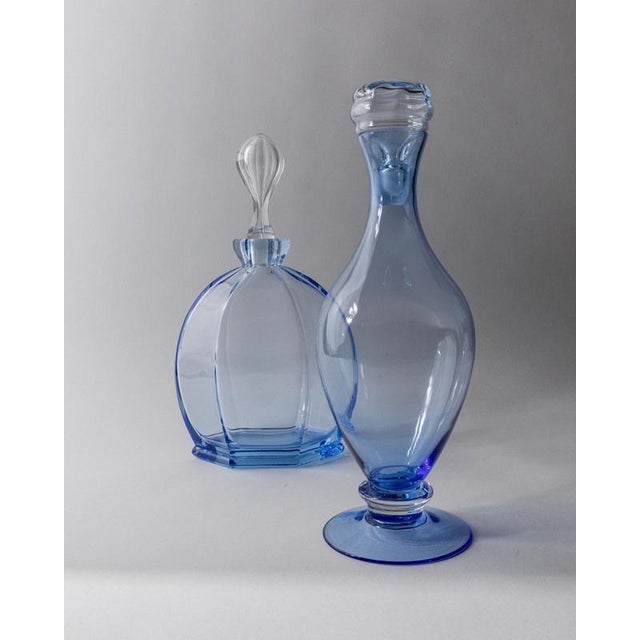 This vintage Murano glass decanter set from 1940s Italy includes two sculptural pieces in deep blue art glass, each with a...