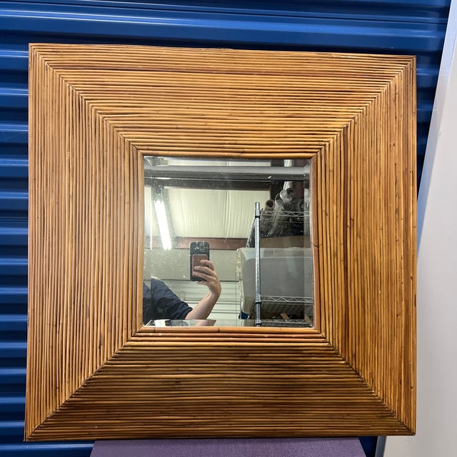 Sculptural faceted pyramid shaped mirror rendered in rattan split reed bamboo with a inset beveled 14" square mirror by...