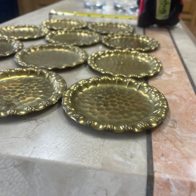 Wonderful hammered brass coasters. Sunflower shape with hammered center and faux bamboo rim. Set of 11
