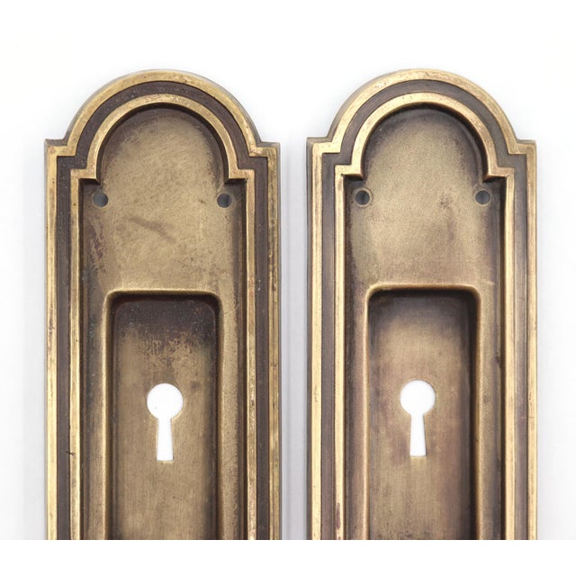 Reclaimed Art Deco style pressed brass recessed pocket door pulls. The original mounting screws are not available. Good...