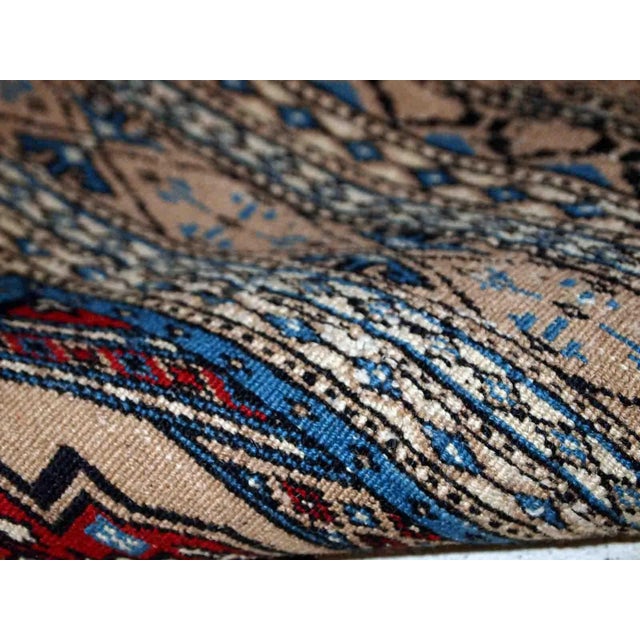 Handmade vintage Uzbek Bukhara rug in original good condition. The rug is from the middle of 20th century in brown and...