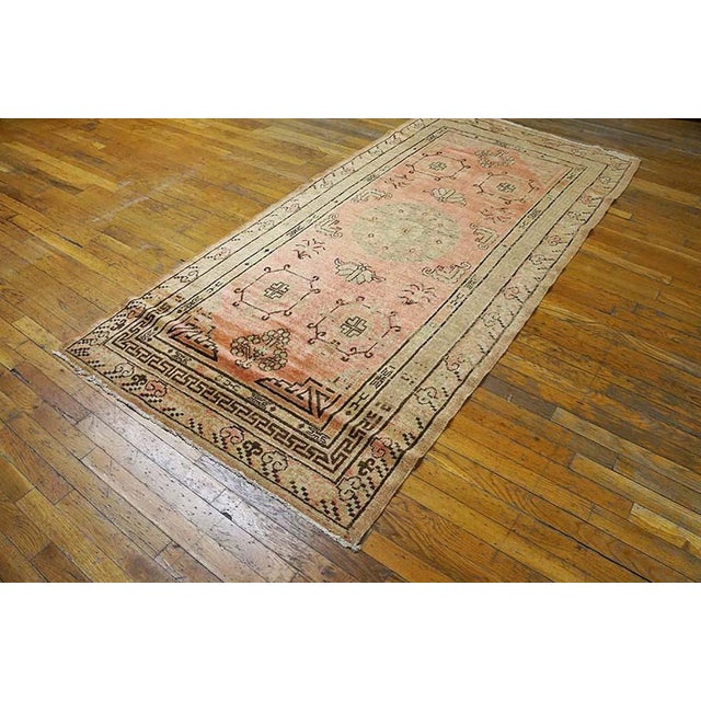Early 20th Century Central Asian Khotan Rug with an soft coral background and yellow patterned border. ( 4' x 8' - 122 x...