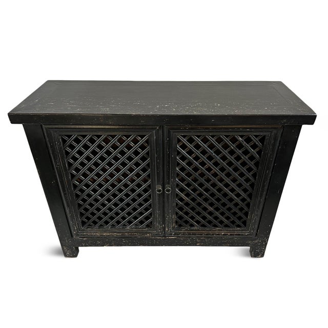 Vintage aged black finish solid wood sideboard with two doors featuring lattice cutout design. Great used as a bar...