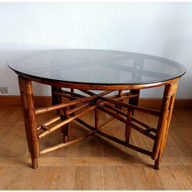Large telescopic rattan table, vintage work circa 1970. X-shaped rattan structure and woven joints. Rotating rattan cleat...