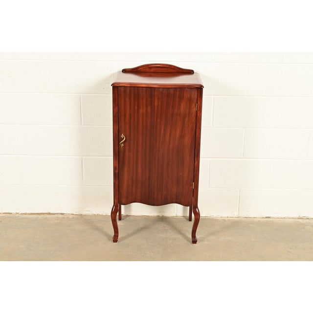 A gorgeous antique Victorian or Queen Anne music cabinet, record cabinet, or bar cabinet USA, Circa 1900 Carved mahogany,...