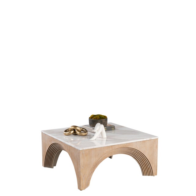 Add a unique twist to your living room with the Paxton Marble Top Coffee Table. The architectural base and the white...