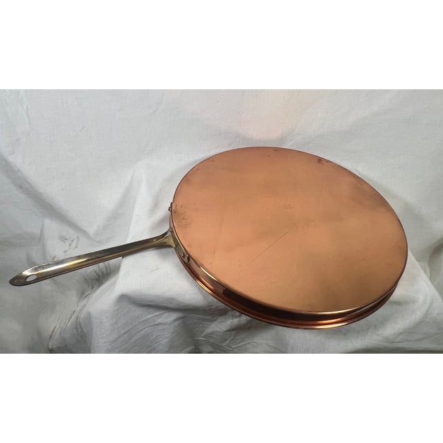 Exquisite copper and brass crepe pan with tin lining. Made in Portugal by Copral. Brass handle has hook for hanging as a...