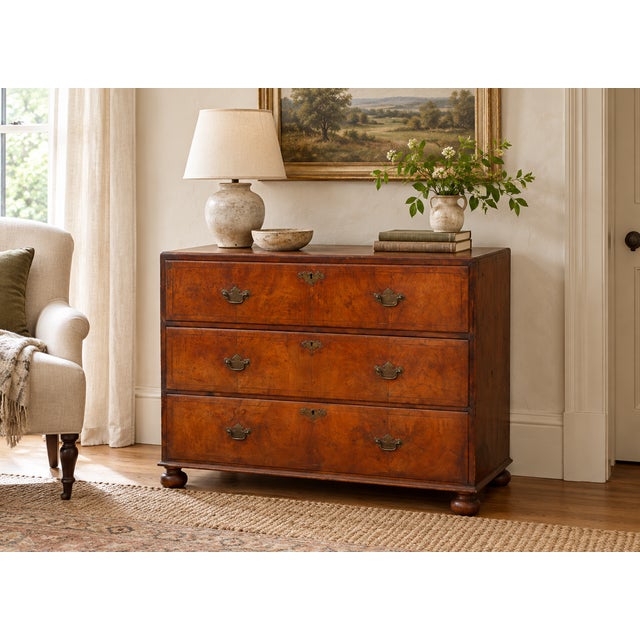 Look closely at the drawer fronts. The burr walnut swirls and clusters into patterns that no two drawers repeat, and the...