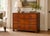 Look closely at the drawer fronts. The burr walnut swirls and clusters into patterns that no two drawers repeat, and the...