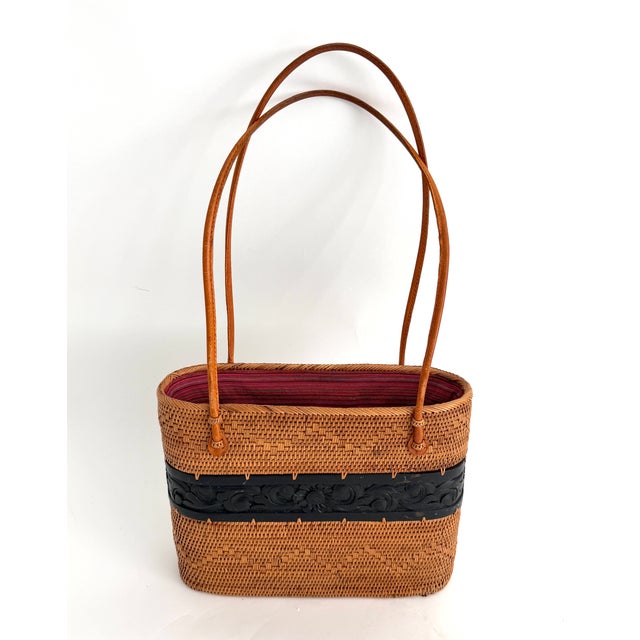 This handwoven basket features the Ata rattan technique that was native to the island of Lomboc. With a hand-carved wood...