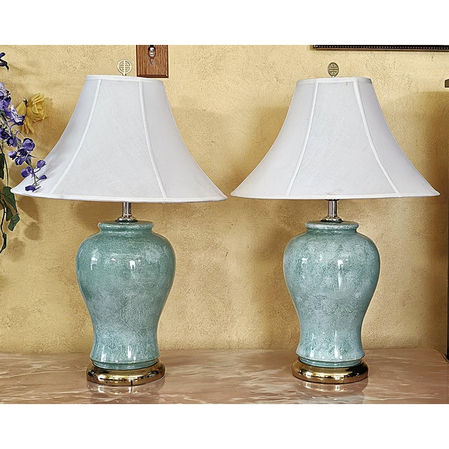 Elegant pair of vintage celadon ceramic table lamps featuring classic ginger-jar silhouettes with beautifully textured...