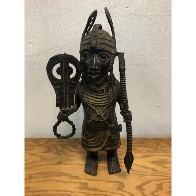Circa late 18th century,Bronze metal male african warrior statue, the standing warrior is holding a sword and a rope