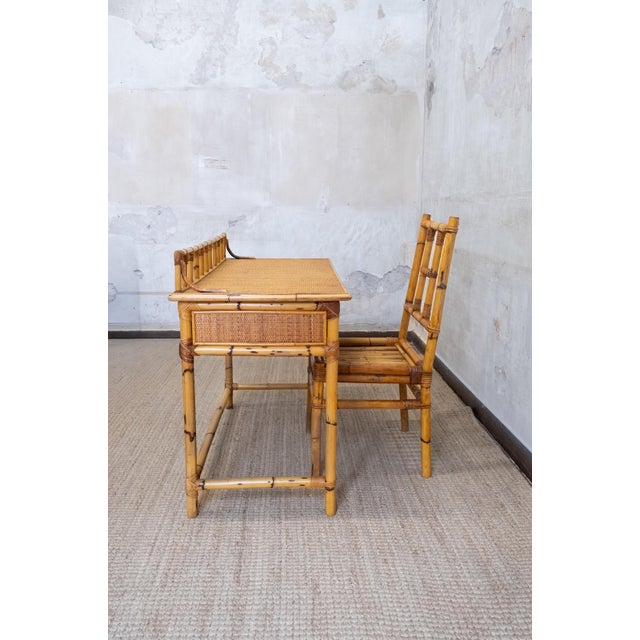 Bamboo and rattan desk with matching chair – 1970s comprising a desk with two drawers and a matching chair. Crafted in...