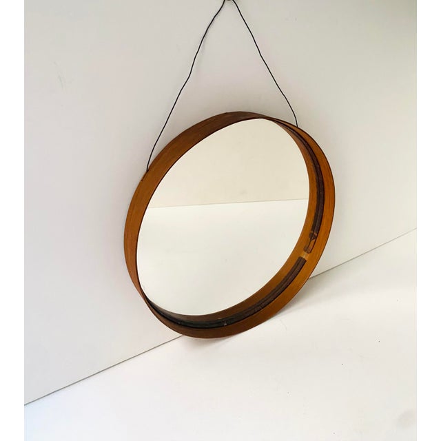 A round brown teak wood wall mirror, Scandinavian Modern Swedish Modern period, by Glas Master, Markaryd, circa 1960s,...