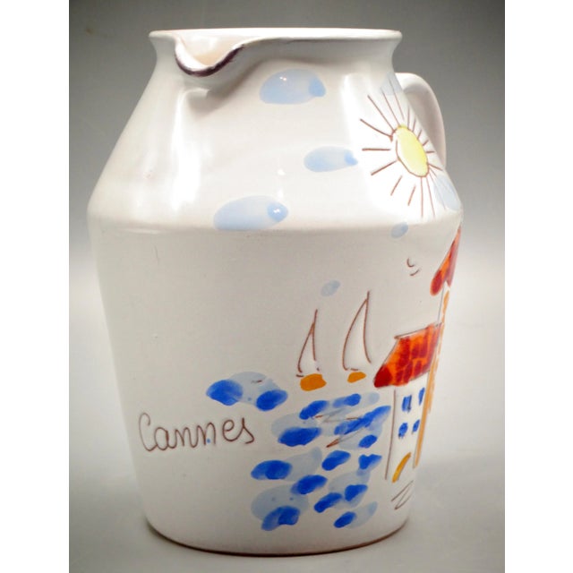 A delightful French pitcher from Cannes, incised and hand painted in the sunny colors of the Côte d'Azur or French...