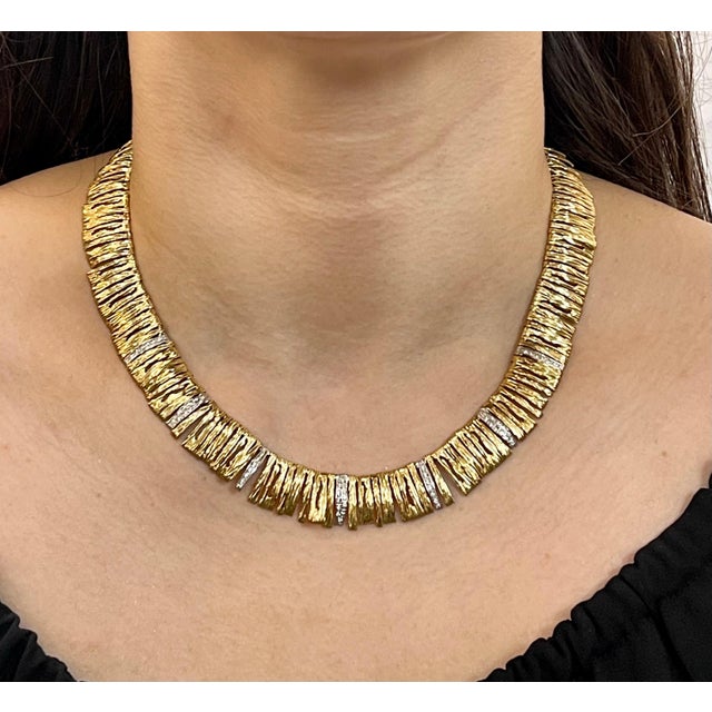 Made of 18k yellow and white gold, the necklace is set with sparkling round cut diamonds that weigh approximately 1.2ct....