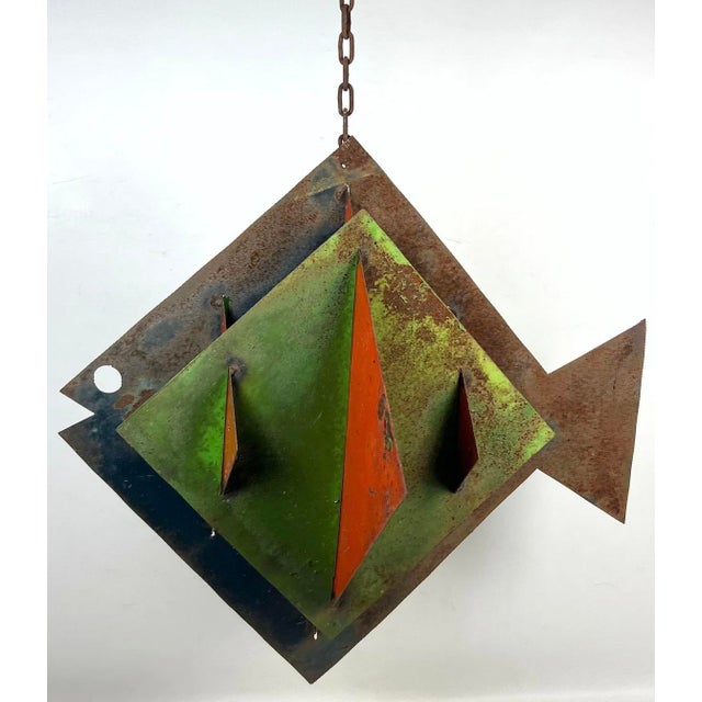 This is a gorgeous brutalist style mid century modern hanging metal fish with weathered and rusted metal plates with green...