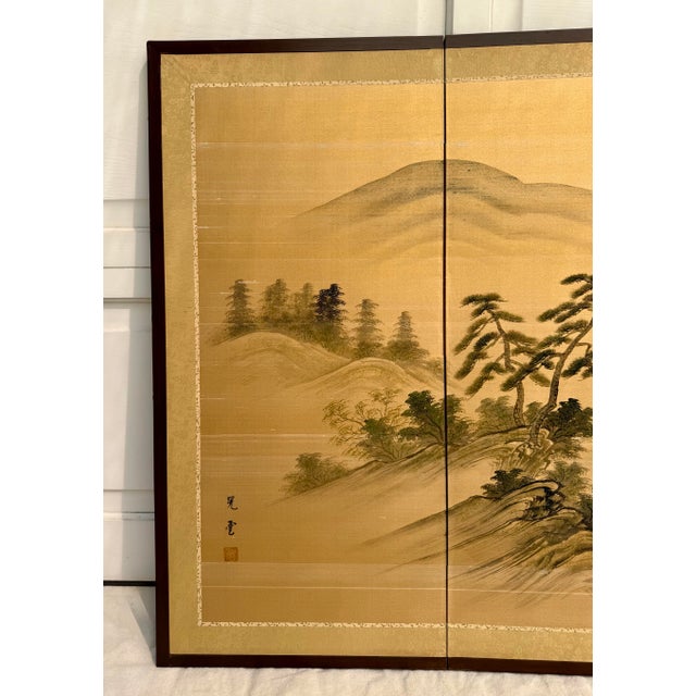 Here is a stunning vintage Japanese-style folding screen featuring a serene hand-painted landscape rendered on silk,...