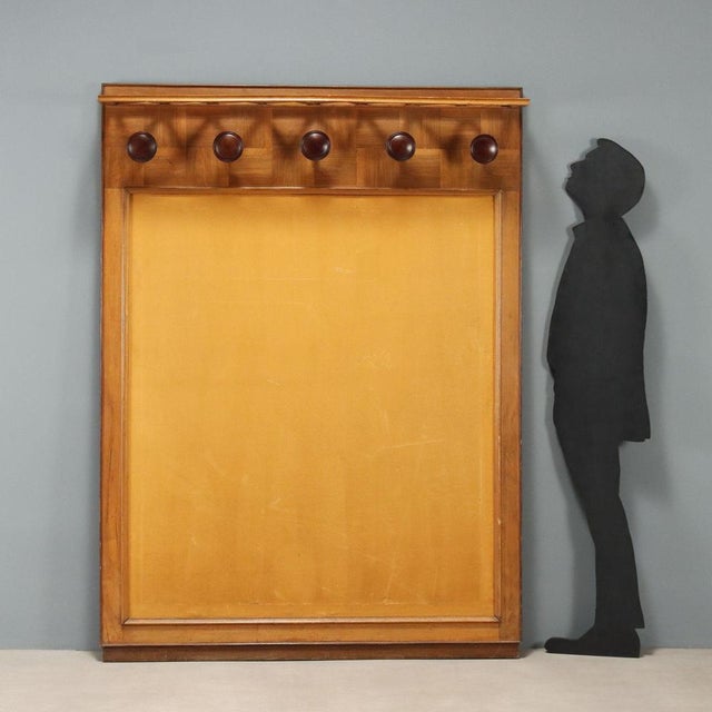 Vintage hallway coat rack with hat rack and oak frame, stained wood knobs, central section in yellow fabric. This piece is...