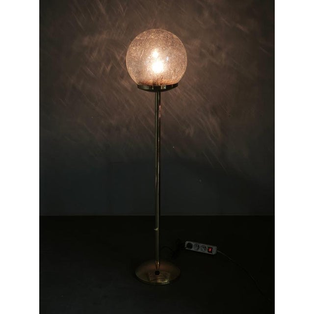 Sculptural space age floor lamp produced in kamenický šenov, czechoslovakia, during the 1970s, featuring a tall brass-...