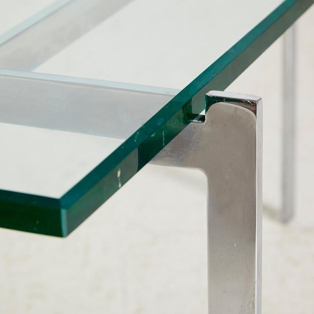 Chrome coffee with angular forms and a hardened glass top from the 1970s. The glass and metal surfaces of the table have...