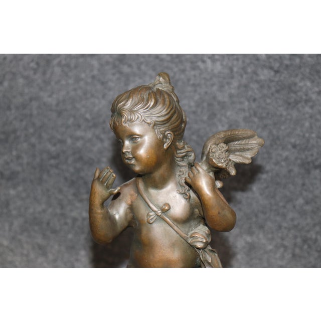 Elegant, romantic, and rich in classical symbolism, this exquisite French bronze putti sculpture is a captivating work of...
