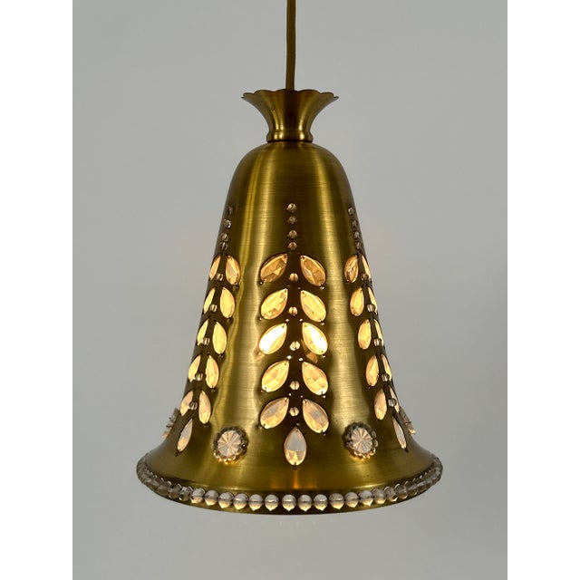 Rare, lovely and highly decorative mid-century modern brass and crystal glass pendant lamp or hanging light. Designed...