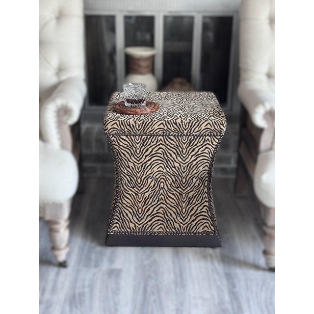 Elevate your space with this striking pair of Bernhardt hourglass ottomans upholstered in a sumptuous zebra-pattern...
