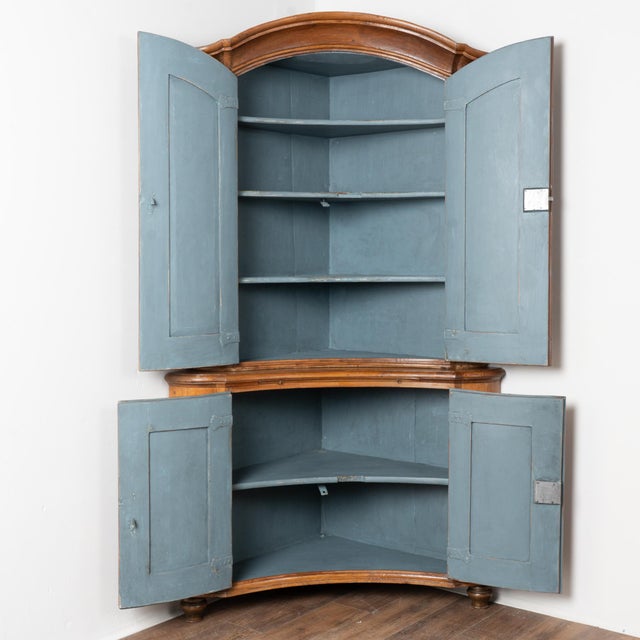 19th-century Swedish pine corner cabinet featuring distinctive concave curved doors in both the upper and lower sections,...