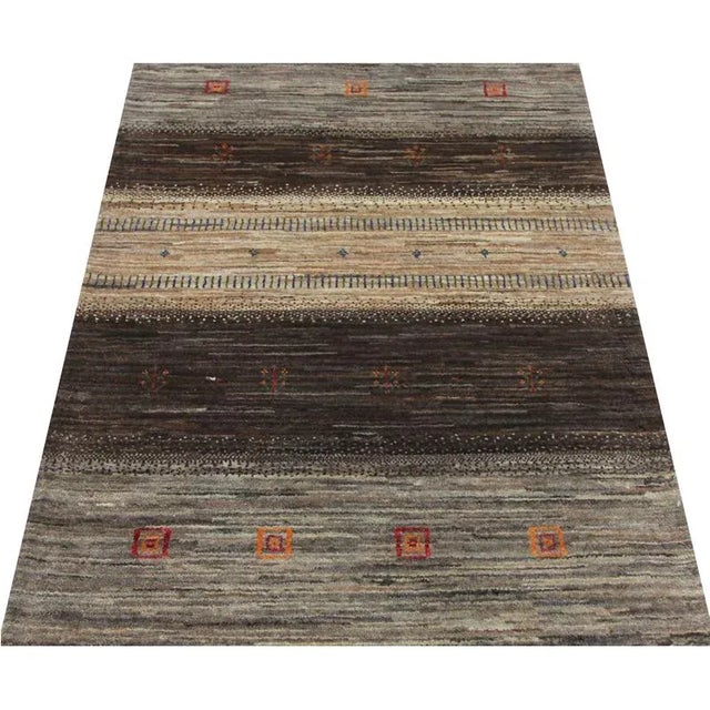 ACTUAL SIZE: 2’10” x 4’5″ PRIMARY COLOR: Brown / Taupe AGE: New MATERIALS: Wool FOUNDATION: Cotton PRODUCTION: Handwoven,...