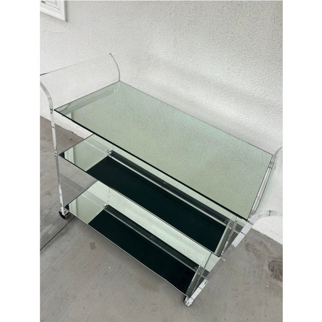 Shlomi Haziza Vintage Lucite Bar Cart with Mirrored Shelves This vintage bar cart in the style of Shlomi Haziza features a...
