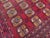 This hand-knotted Ersari Bokhara rug features dense rows of octagonal "elephant's foot" guls in gold, rust, and ivory set...