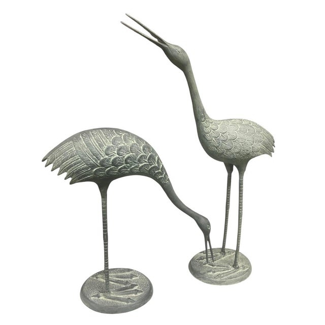 This striking pair of life-sized or near-life-sized vintage bronze garden sculptures depicts two elegant cranes,...