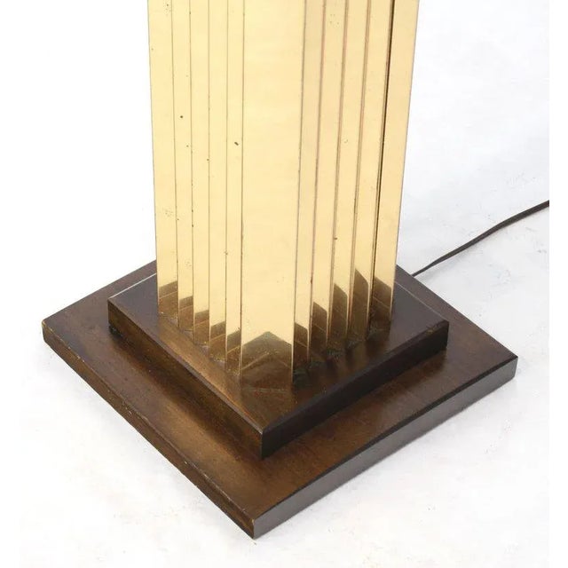 Mid-Century Modern extruded brass walnut caps pedestal shape floor lamp. Strong influence Paul Evans Cityscape lines.