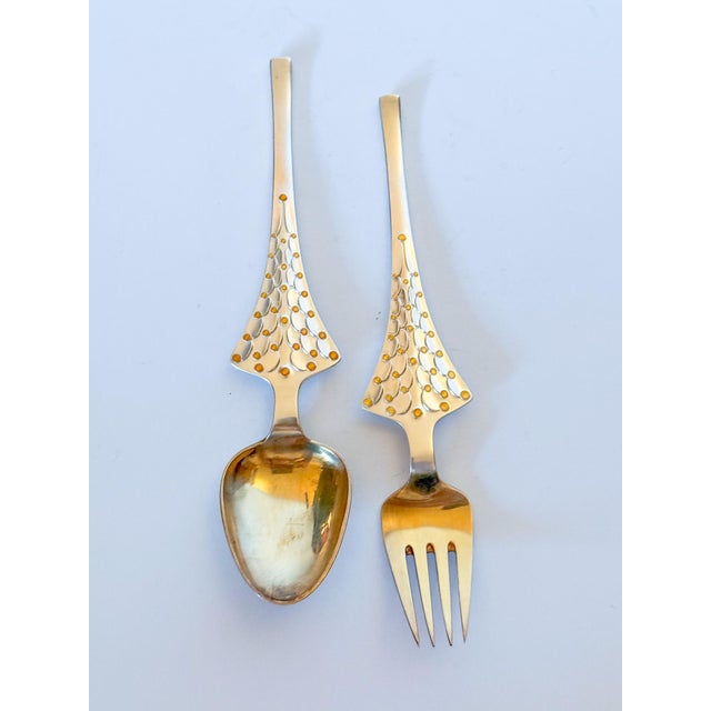 Danish gilded sterling silver and enamel Christmas fork and spoon set from Anton Michelsen of Copenhagen, Denmark. At the...