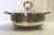 Classic casserole dish with lid. This round serving dish and lid are made of silverplate, and stamped 'Italy' on the...