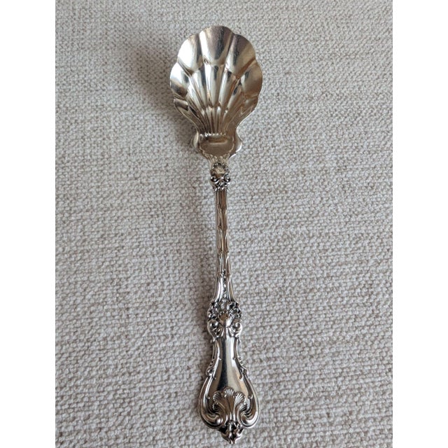 A lovely shell motif solid sterling silver preserve spoon in the "King Edward" pattern by Whiting Manufacturing Co. The...