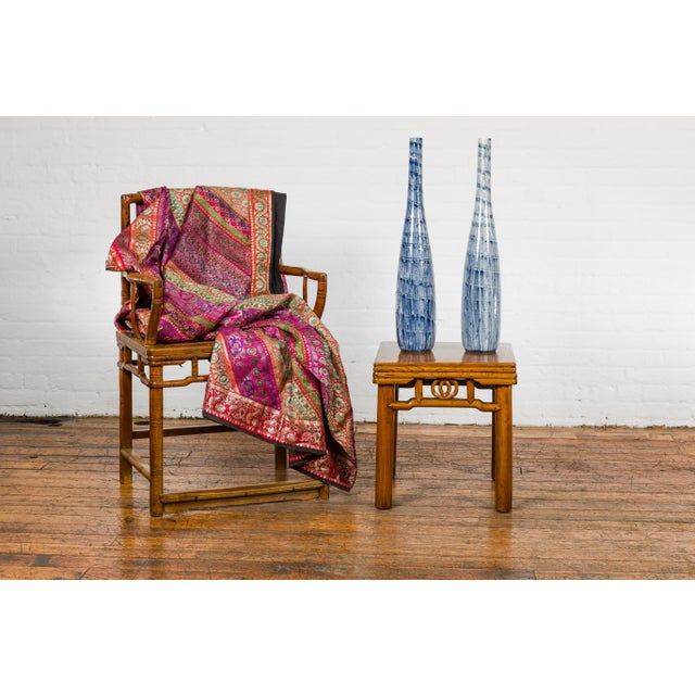 Two slender blue ceramic handmade vases with spiraling and dripping décor and narrow mouths, priced and sold each. Evoking...