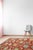 A hand-knotted wool rug, made in India and measuring 5' x 8'. Floral drawing carried across the field inside a traditional...