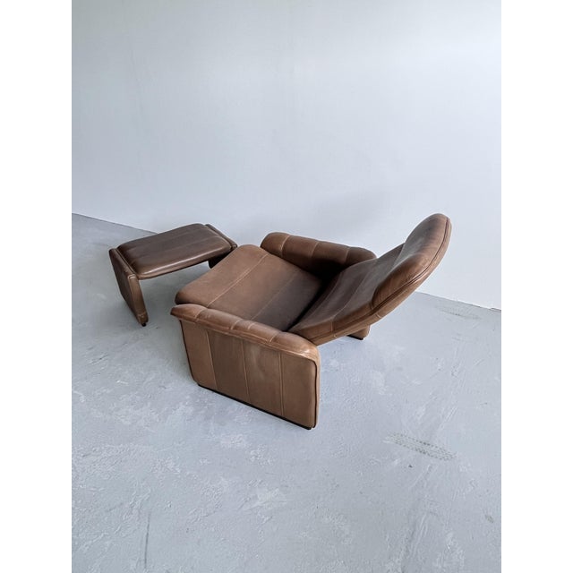 A beautiful leather armchair with a footstool from the Swiss manufacturer De Sede. Model Ds50 Exclusive. Buffalo leather....