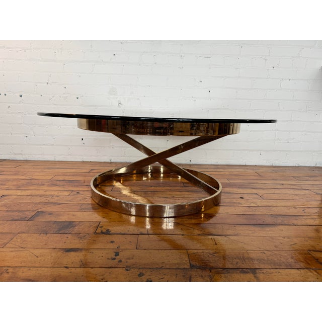 Round glass and chrome table designed in the style of Milo Baughman’s zig zag table. Rises 15” off the ground and is...