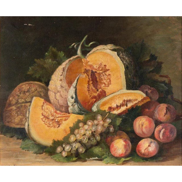 This early 20th-century French oil painting on canvas portrays an abundant still life of a large melon open with slices...