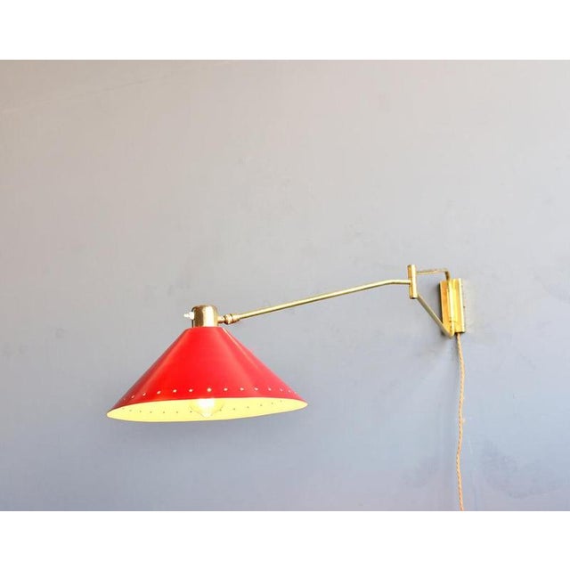 René Mathieu for Lunel Wall Lamp Circa 1950s - Brass shade and arm - Red colour, with star pattern on shade - Light takes...