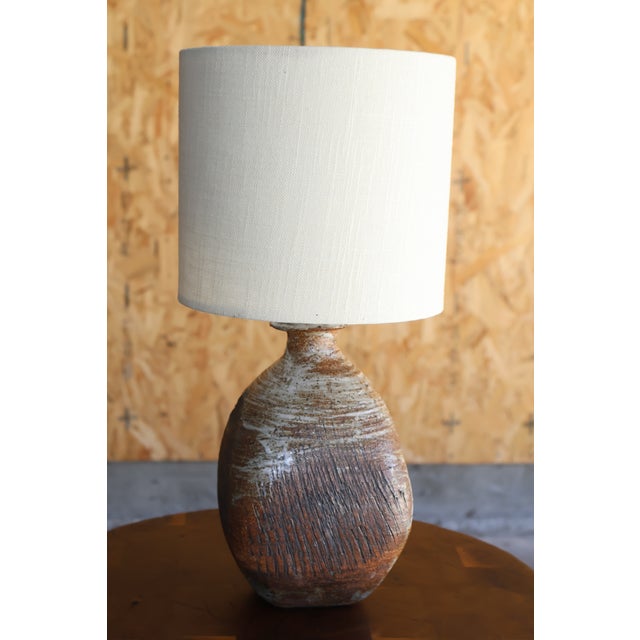 A beautiful hand-made studio pottery ceramic lamp, California, 1960s. Newly rewired with a custom-made linen shade. Wired...