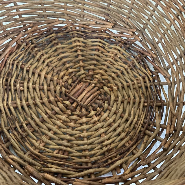 Bring rustic charm and timeless utility to your home with this exceptional early 20th-century hand-woven basket. Crafted...