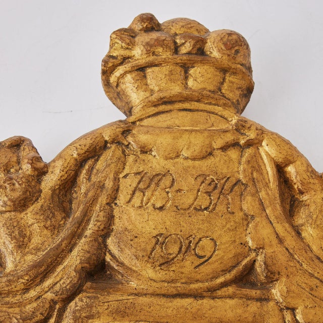 Gilded mirror from 1919 a gilded mirror dated 1919 with the size 52 cm x 21 cm. wonderful carved decoration in gold....