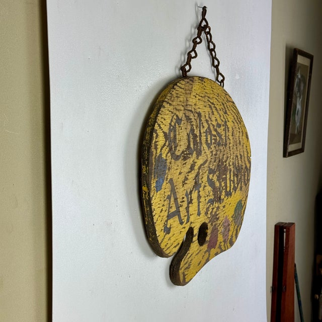 A marvelous and unique double sided wooden trade sign that hung outside the "Colosi Art Studio". In the shape of an artist...